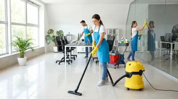 Professional cleaning staff vacuuming and wiping glass in a corporate office, representing local service-based companies that rely on lead-generating WordPress websites.